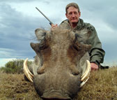 of Kilimanjaro Custom Rifles Founder Erik Eike and Trophy of Warthog